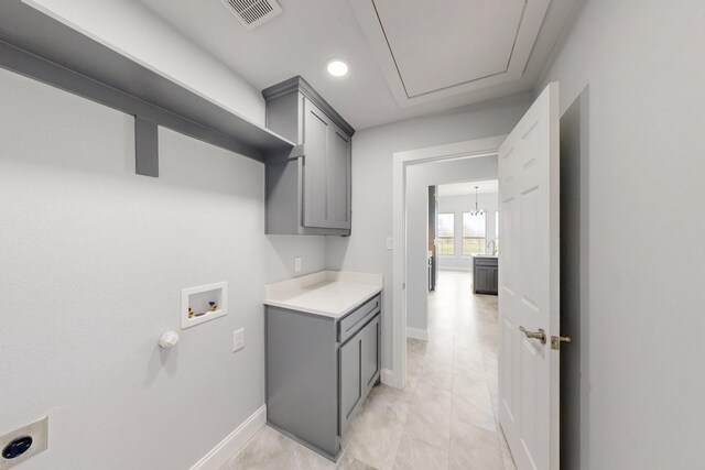 laundry area with baseboards, visible vents, cabinet space, and washer hookup