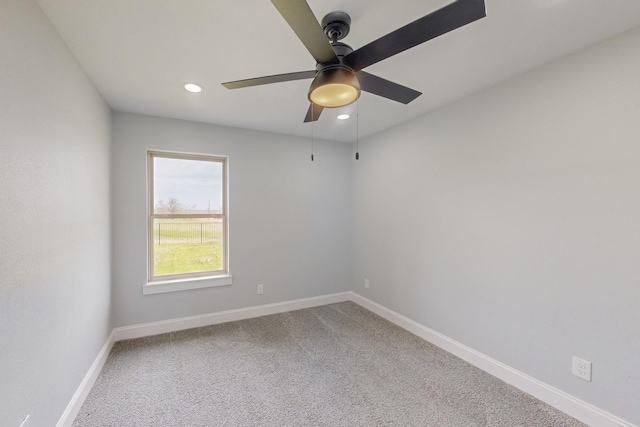 carpeted spare room with recessed lighting, a ceiling fan, and baseboards