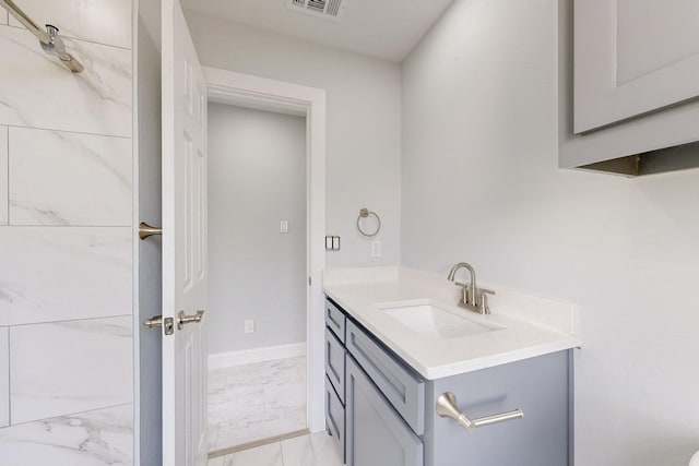 bathroom with visible vents, baseboards, marble finish floor, and vanity