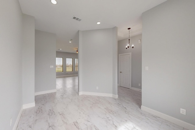 spare room with recessed lighting, baseboards, visible vents, and a chandelier