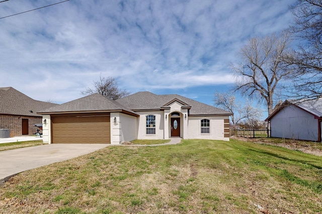 view of front of home with brick siding, fence, concrete driveway, a front yard, and a garage