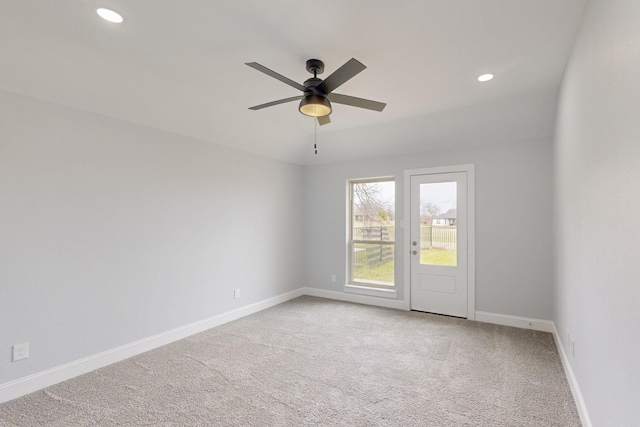 carpeted spare room with recessed lighting, ceiling fan, and baseboards