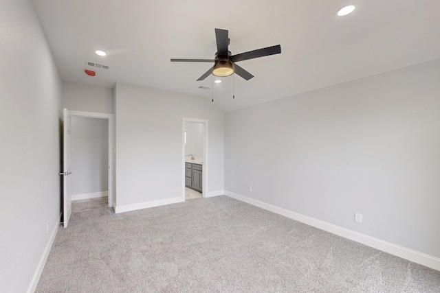 unfurnished bedroom featuring visible vents, ensuite bath, recessed lighting, baseboards, and light colored carpet