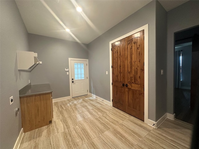 entrance foyer with light wood-style floors and baseboards