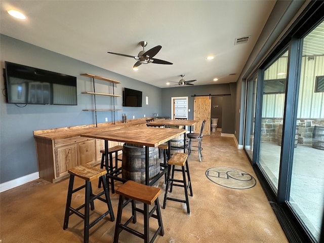 dining room featuring baseboards, visible vents, recessed lighting, ceiling fan, and a barn door