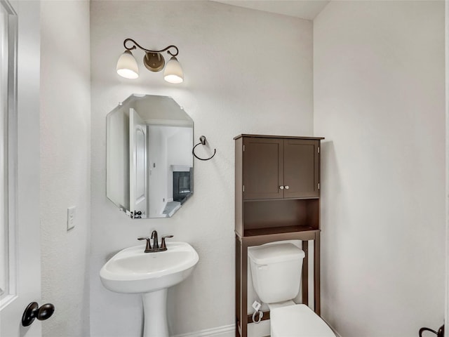 bathroom featuring toilet and a sink