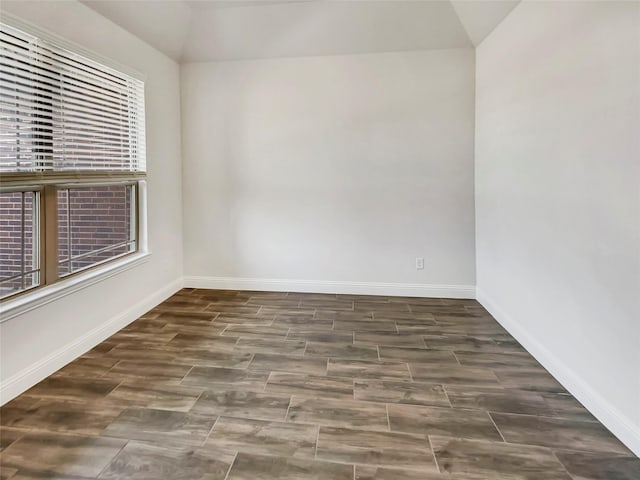 empty room with baseboards and wood finished floors