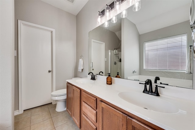 bathroom featuring tile patterned floors, a shower stall, a garden tub, and a sink