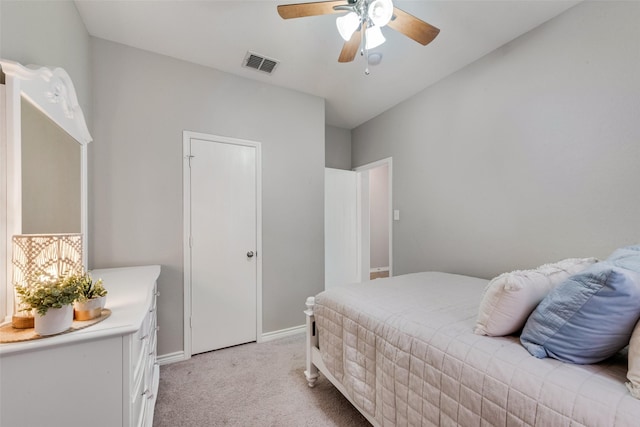 bedroom featuring visible vents, baseboards, light colored carpet, and a ceiling fan