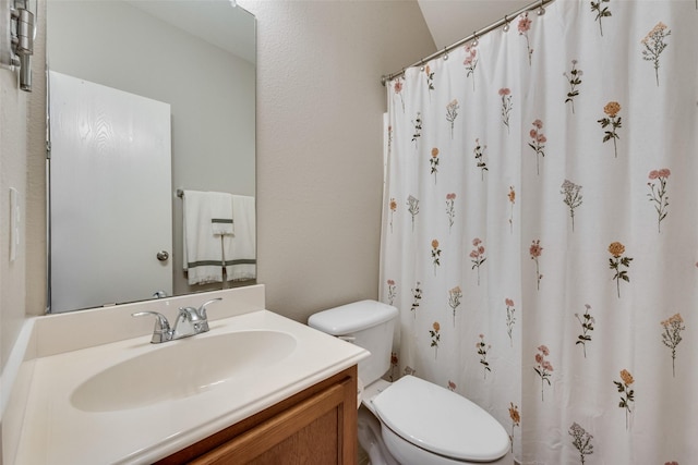 bathroom with vanity, toilet, and a shower with curtain