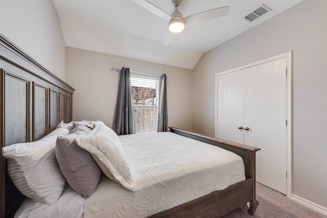 carpeted bedroom featuring visible vents, a ceiling fan, and vaulted ceiling