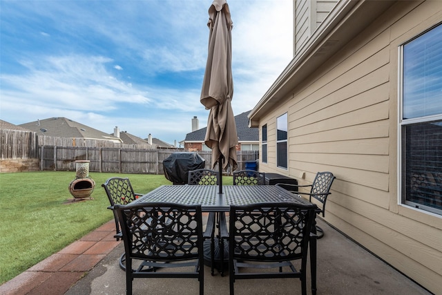 view of patio featuring a fenced backyard, area for grilling, and outdoor dining space