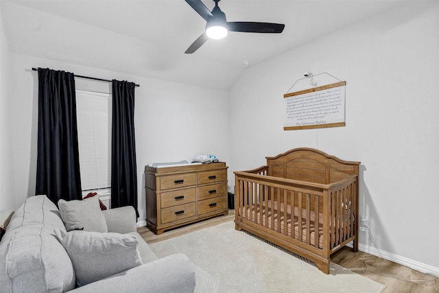 bedroom featuring baseboards, wood finished floors, a ceiling fan, and vaulted ceiling