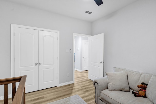 interior space with a ceiling fan, baseboards, visible vents, light wood-style flooring, and a closet