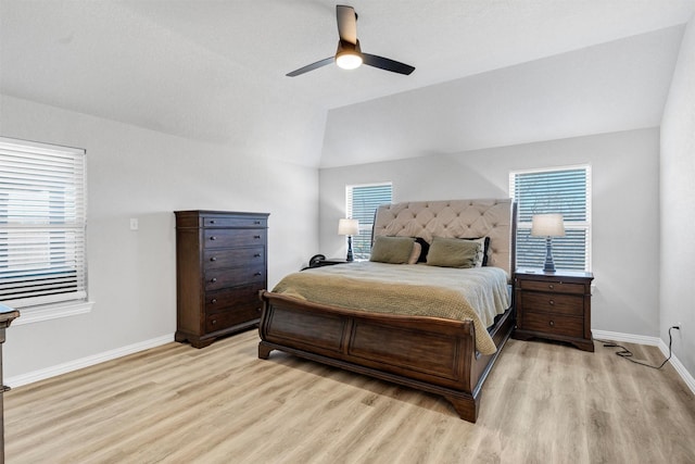 bedroom featuring lofted ceiling, light wood-style flooring, baseboards, and ceiling fan