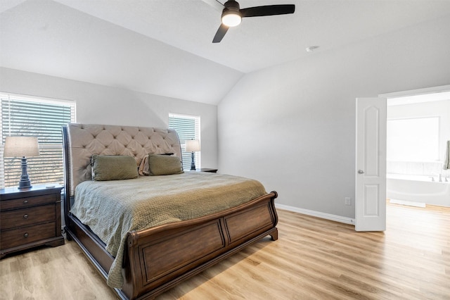 bedroom with light wood finished floors, multiple windows, and vaulted ceiling