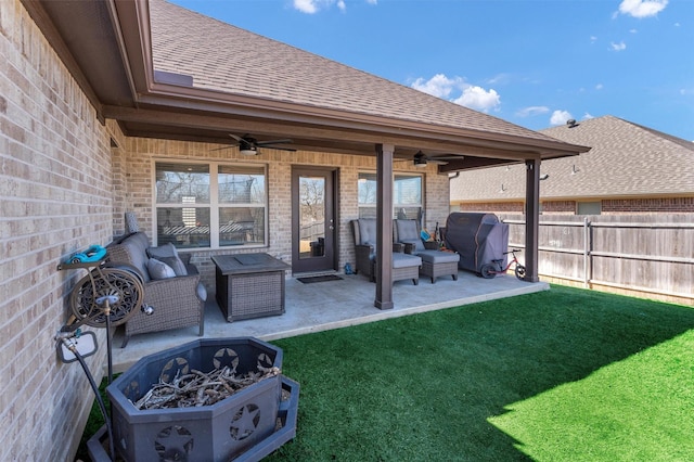 view of patio featuring a fire pit, area for grilling, a ceiling fan, and fence