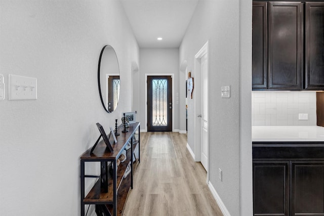 interior space featuring light wood-type flooring and baseboards