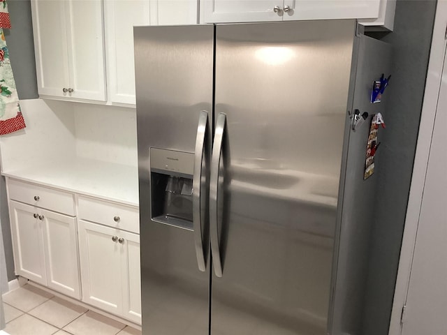 6930 Trailcrest Dr, Dallas, TX 75232 - kitchen with stainless steel fridge with ice dispenser, white cabinets, light tile patterned floors, and light countertops
