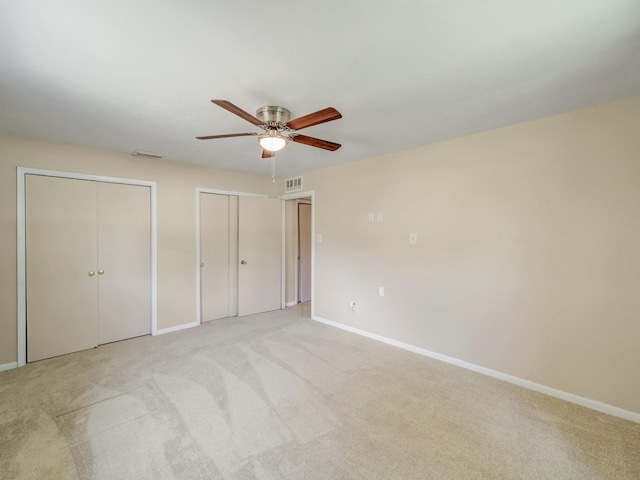 6930 Trailcrest Dr, Dallas, TX 75232 - unfurnished bedroom featuring multiple closets, light colored carpet, and ceiling fan