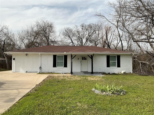 ranch-style home featuring brick siding, a front lawn, concrete driveway, and a garage