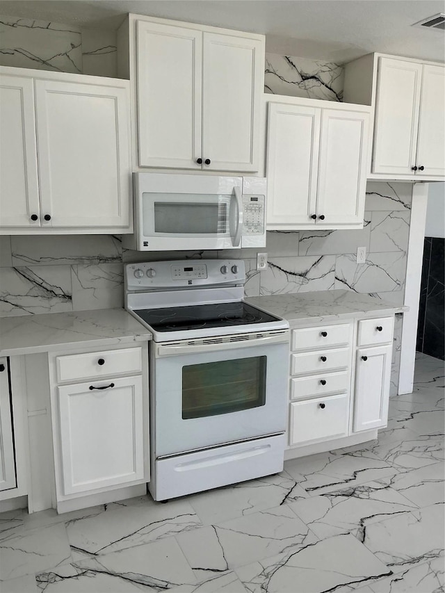 kitchen featuring tasteful backsplash, visible vents, white cabinets, and white appliances