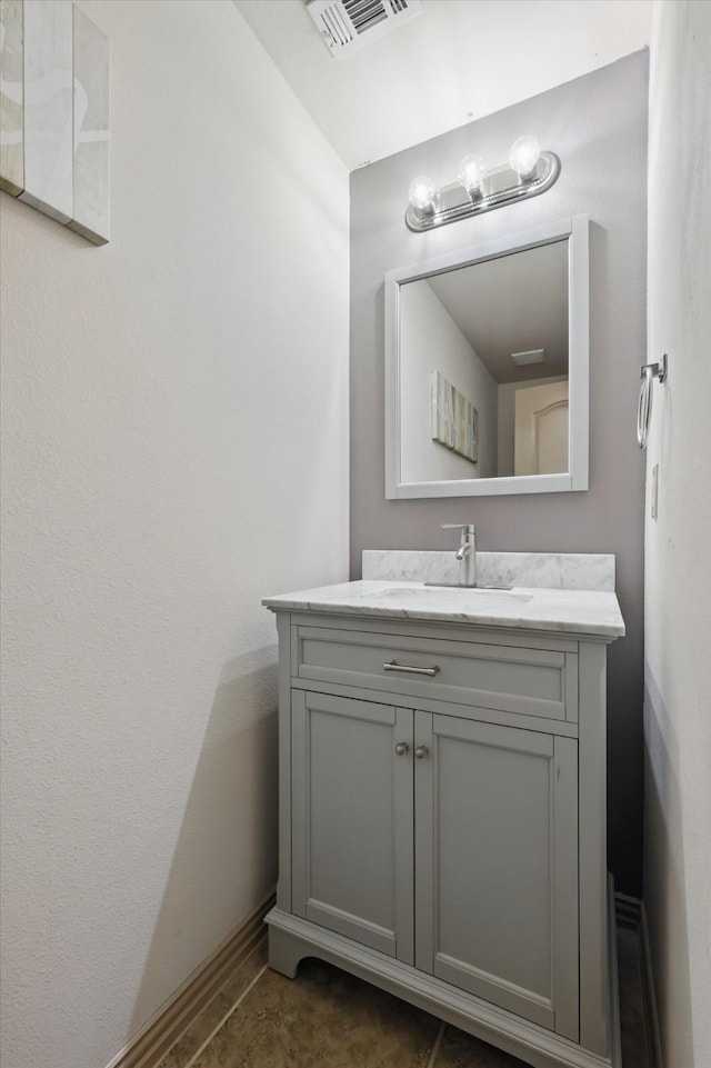 bathroom with visible vents, baseboards, and vanity