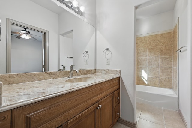 bathroom featuring tile patterned flooring, baseboards, bathtub / shower combination, vanity, and a ceiling fan