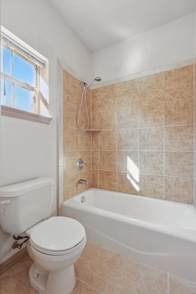 bathroom with tile patterned floors, toilet, and  shower combination