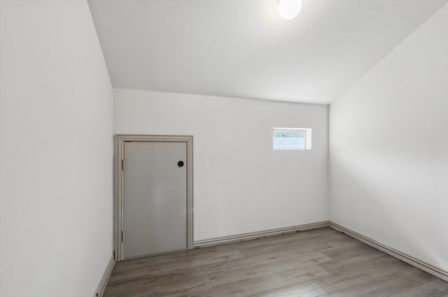 spare room featuring light wood-type flooring and baseboards