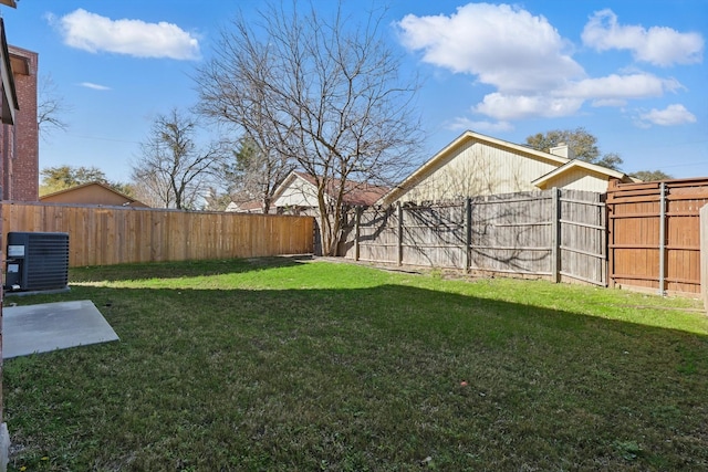 view of yard featuring central AC unit and a fenced backyard