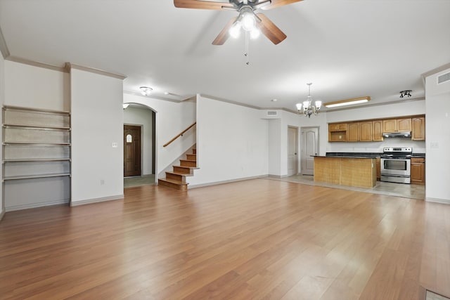 unfurnished living room featuring light wood finished floors, visible vents, crown molding, stairway, and ceiling fan with notable chandelier