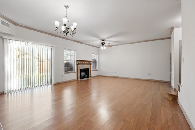 unfurnished living room featuring visible vents, baseboards, ornamental molding, light wood-style flooring, and a tile fireplace