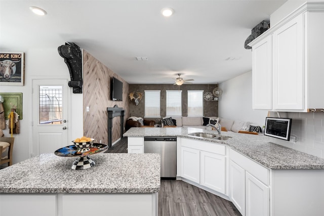 kitchen featuring a sink, dishwasher, white cabinets, and a healthy amount of sunlight