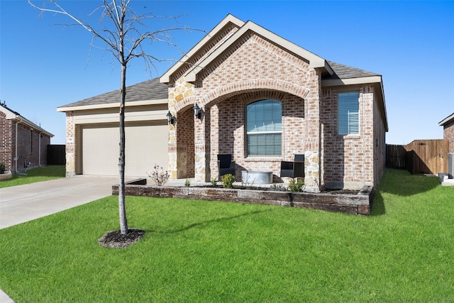 french country inspired facade featuring a front lawn, driveway, fence, a garage, and brick siding