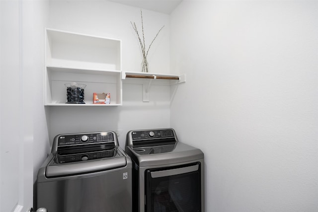 clothes washing area with laundry area and independent washer and dryer