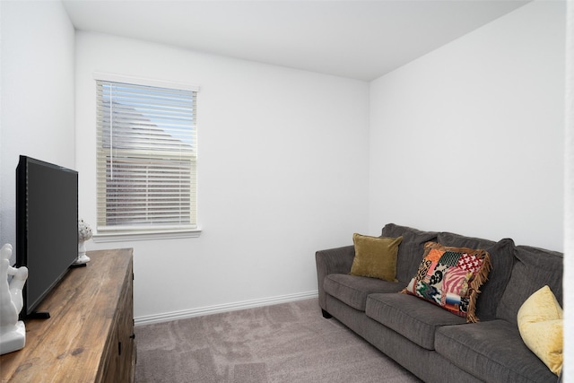 carpeted living area featuring baseboards