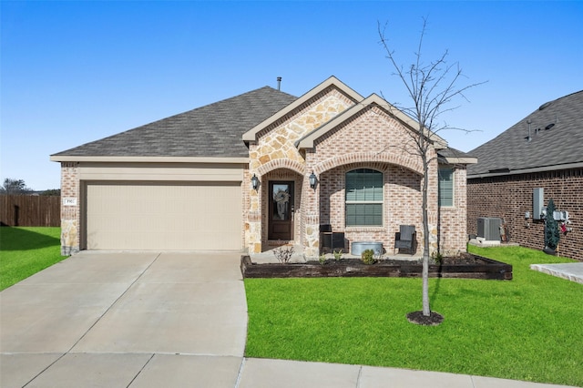 view of front of house with roof with shingles, an attached garage, concrete driveway, a front lawn, and brick siding