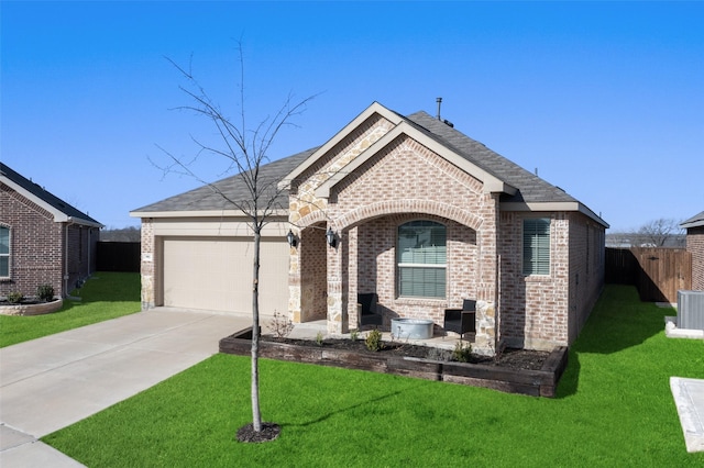 french provincial home with concrete driveway, a garage, brick siding, and a front yard