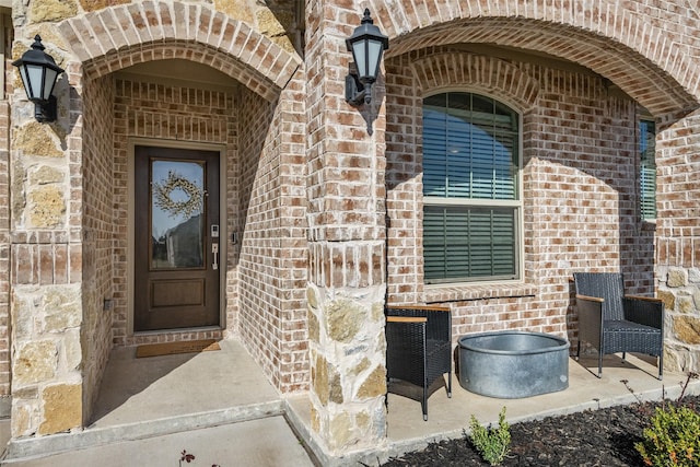 view of exterior entry with brick siding