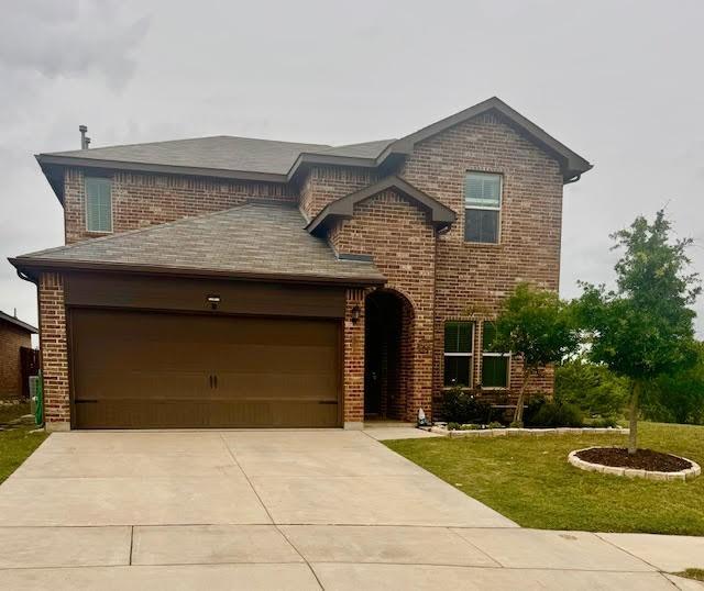 100 Green Water Dr, Fort Worth, TX 76131 - view of front of home with brick siding, driveway, an attached garage, and a front yard