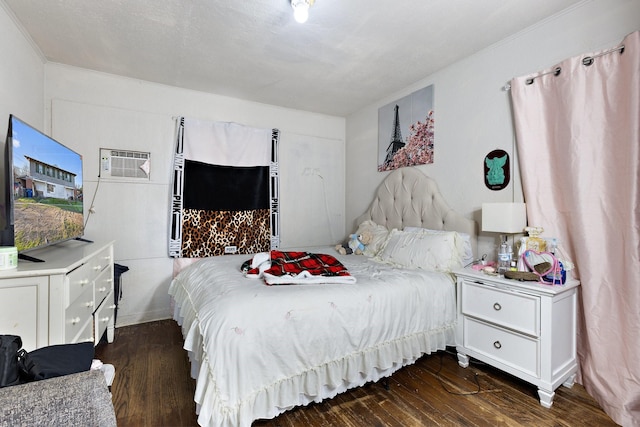 bedroom with an AC wall unit and dark wood-style floors