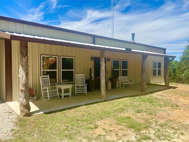 back of house featuring metal roof and a patio area