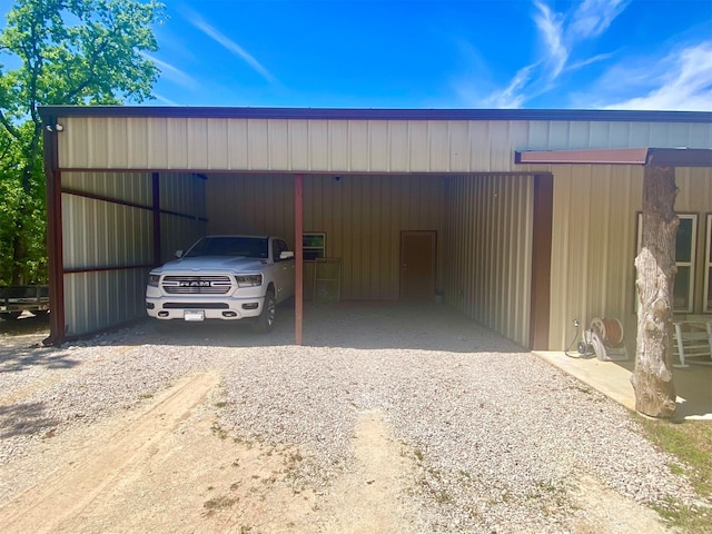 view of pole building featuring gravel driveway and an attached carport