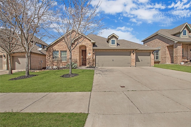 view of front of house featuring driveway, a front lawn, an attached garage, a shingled roof, and brick siding