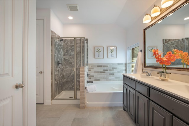 full bathroom featuring a garden tub, visible vents, a shower stall, and a sink