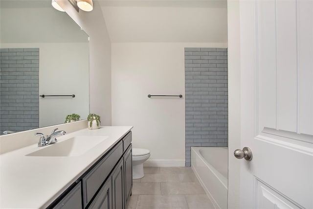 full bath featuring tile patterned flooring, toilet, vanity, and baseboards