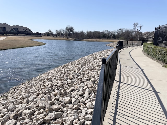 property view of water featuring fence