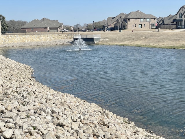 property view of water featuring a residential view and fence