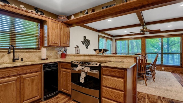 kitchen featuring beam ceiling, a peninsula, a sink, decorative backsplash, and electric stove